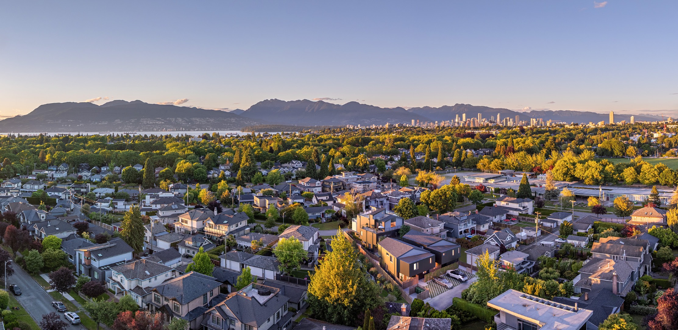 Aerial photograph of Vancouver’s West Side with the city and mountains beyond.
