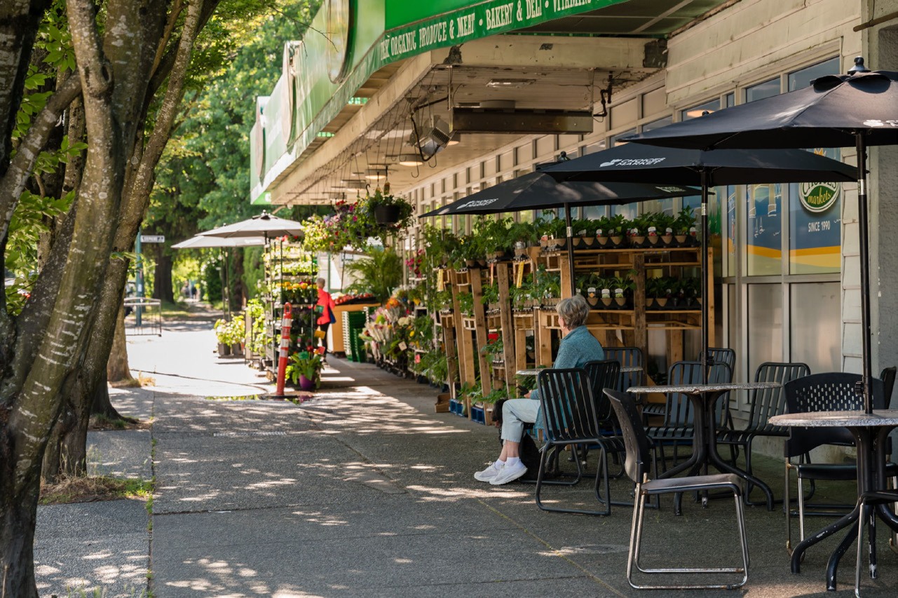 Local storefronts and a tree-lined sidewalk.